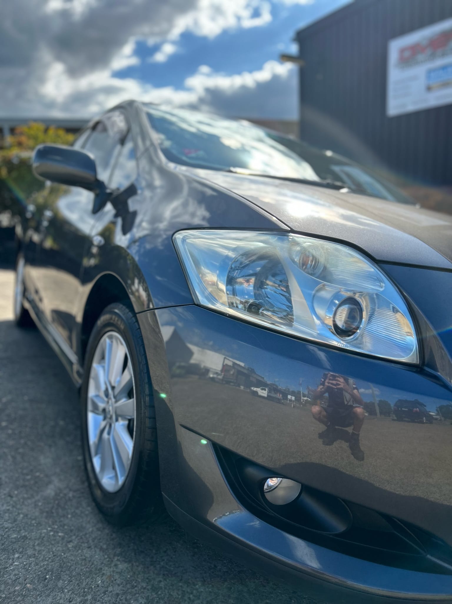 Dark sedan front panel with mirror-like paint correction finish